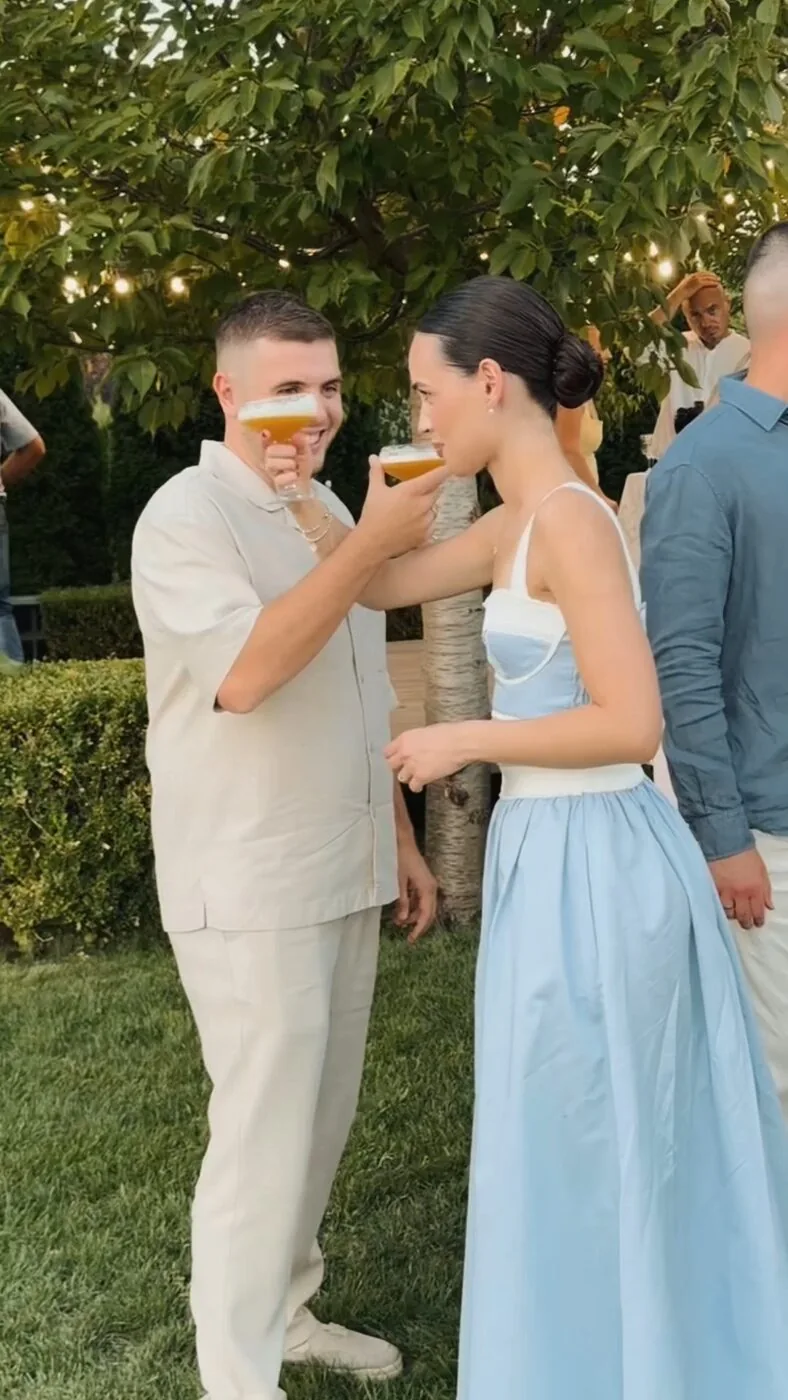 A couple clinking glasses at the party