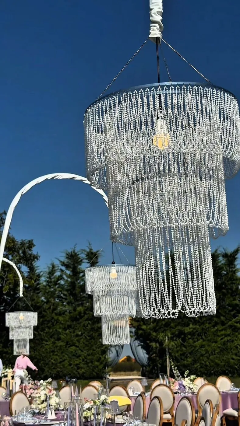 Chandeliers above the wedding tables at sunset